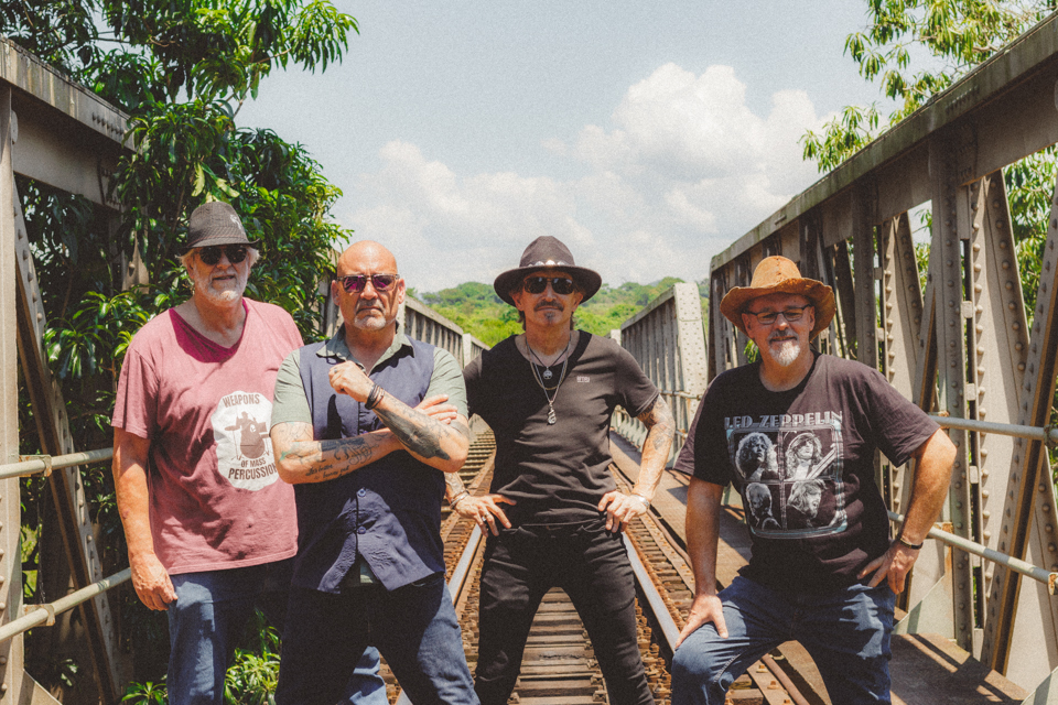 Musicians standing apart on railway tracks